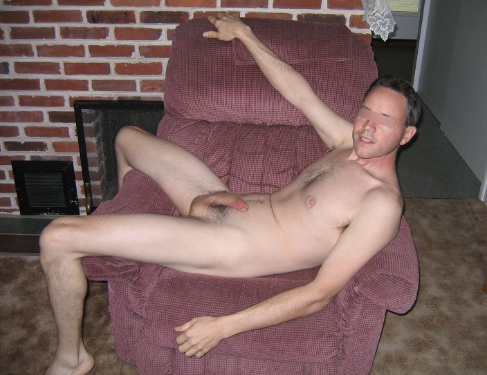 Naked and hairy on red recliner