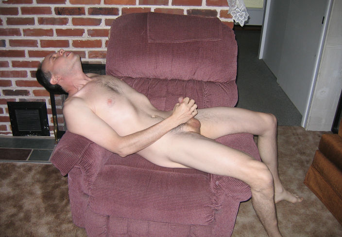 Naked and hairy on red recliner