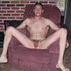 Naked and hairy on red recliner